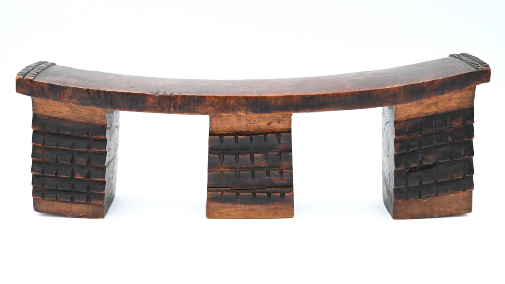 wide wooden headrest with three block-like supports