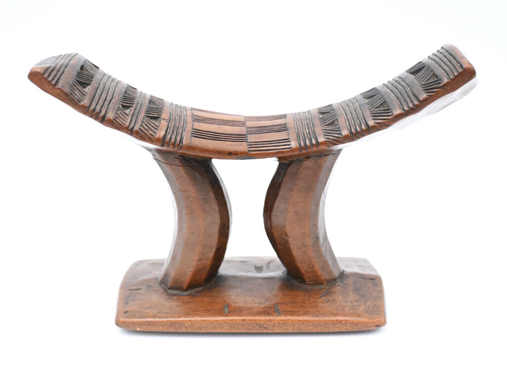 Wooden headrest with geometric carving on the top
