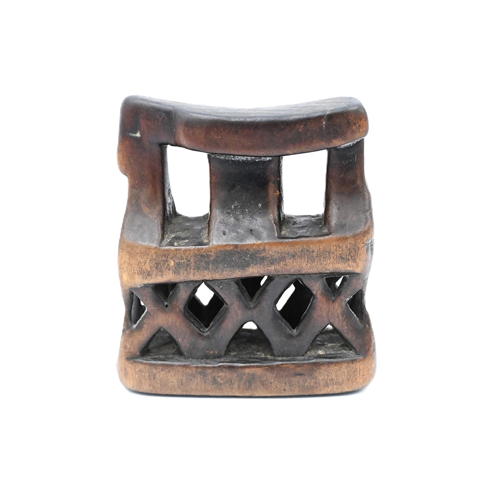 small wooden headrest with x-shaped supports