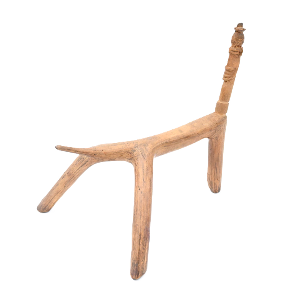 wooden headrest with three legs and one part standing up from the cradle