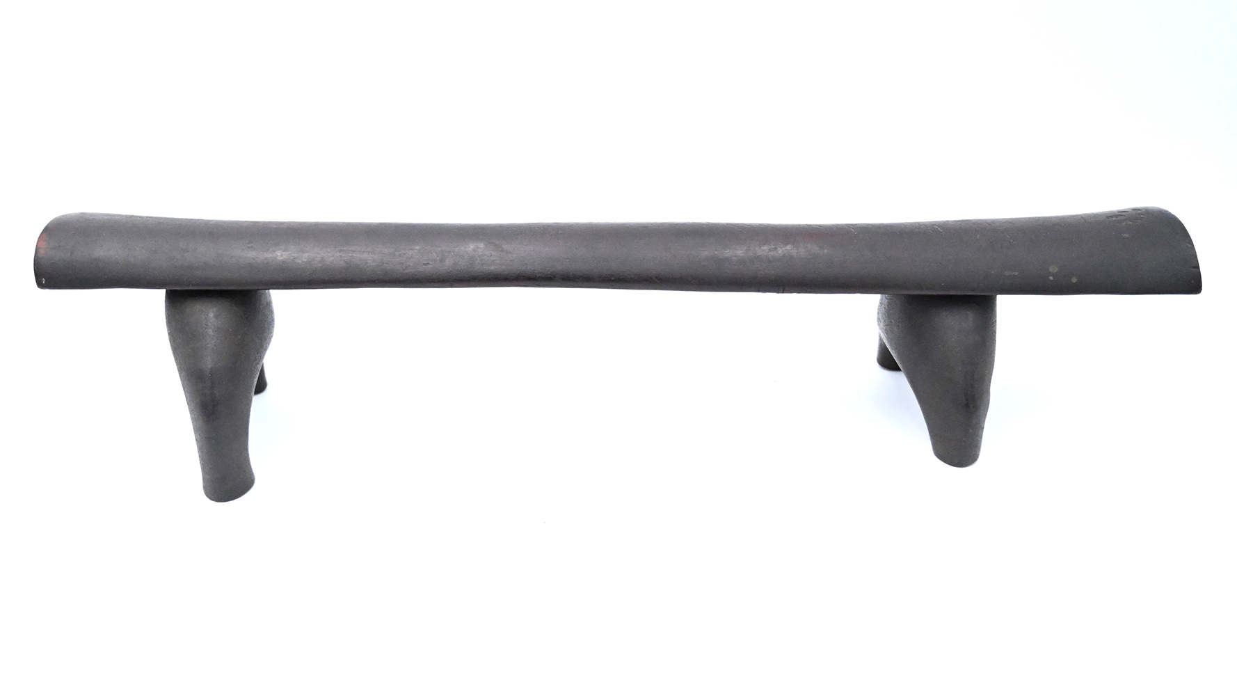 long wooden headrest with four legs