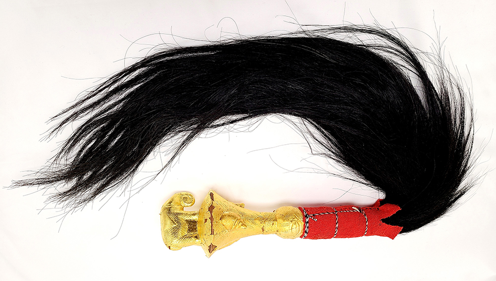 Fly whisk with gold covered handle