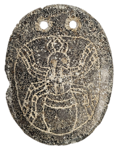 stone pendant with carving of a spider